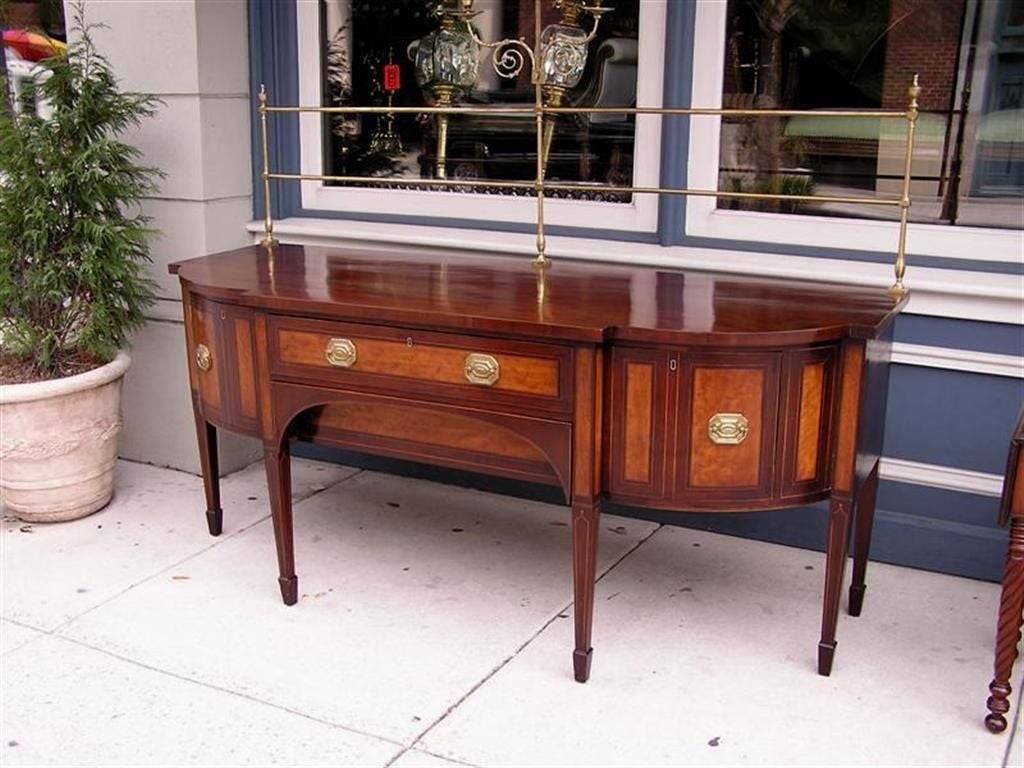 English Mahogany Hepplewhite satinwood inlaid sideboard with double bottle drawers, linen and silver drawers, side chamber pot drawer, original brasses with flanking urn finials and candelabra gallery, and resting on the original tapered legs with