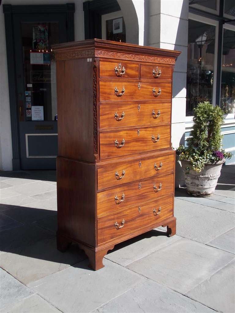 English Chippendale mahogany graduated chest on chest with carved candle light molding, fret work,  Rococo brasses, and terminating on the original Chippendale bracket feet. All Original.  Late 18th Century