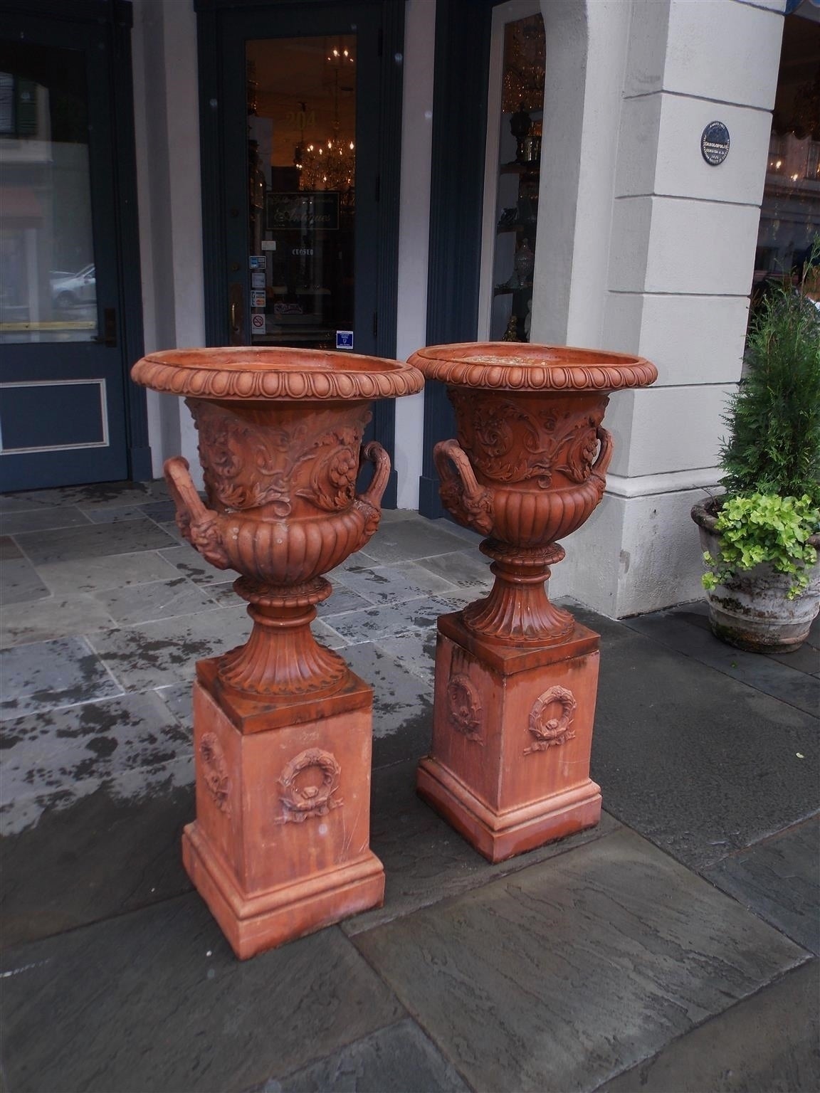 Neoclassical Pair of Italian Terracotta Floral Urns on Raised Plinths, Circa 1840 For Sale