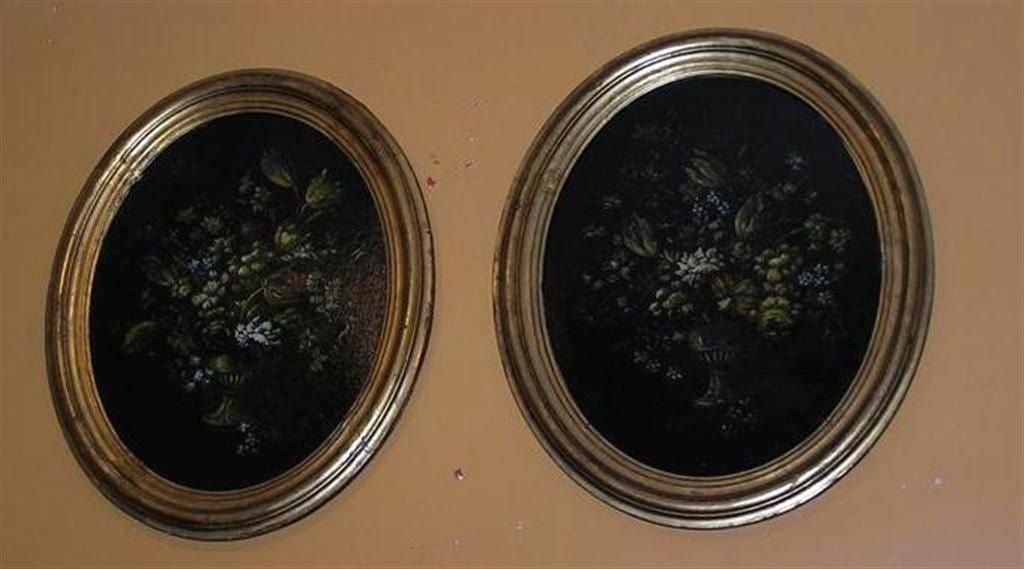 Pair of French oval oil on canvas floral arrangement paintings in original gold gilt frames.