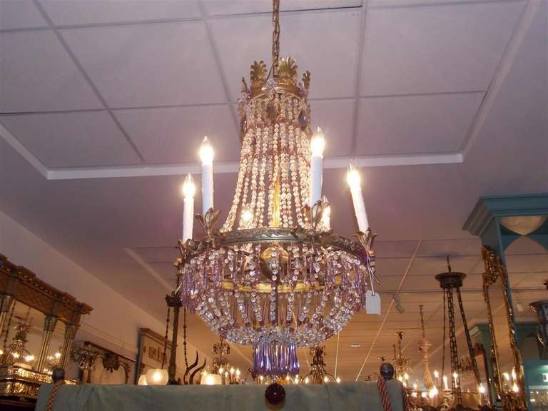 French gilt bronze and crystal six light chandelier with filigree canopy, centered floral and ribbon ring, amethyst prisms, and  terminating with a amethyst crystal ball.  Originally candle powered and has been electrified. Early 19th Century