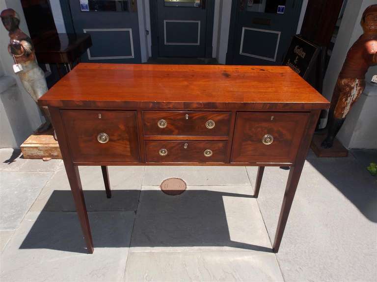 American mahogany four drawer hunt board with original brasses terminating on tapered legs. Early 19th Century.