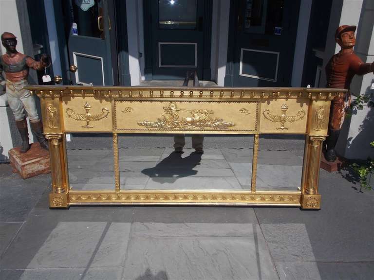 English Adam gilt over mantel mirror with carved mythological figures, acorn motif, flanking urns and Corinthian columns. Early 19th Century.
