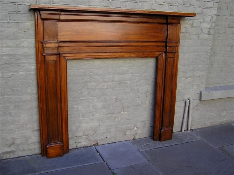 American White Pine fire place mantel with carved molded edges,  one board back, and rectangular carved vertical legs with squared plinths . Early 19th Century . Fire Box Dim.  40