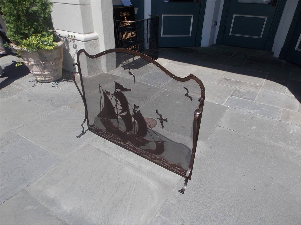 French bronze free standing serpentine nautical fire screen with sailing Frigate ship, seagulls, flanking dragon motif, and terminating on scrolled chased feet, Mid-19th century.