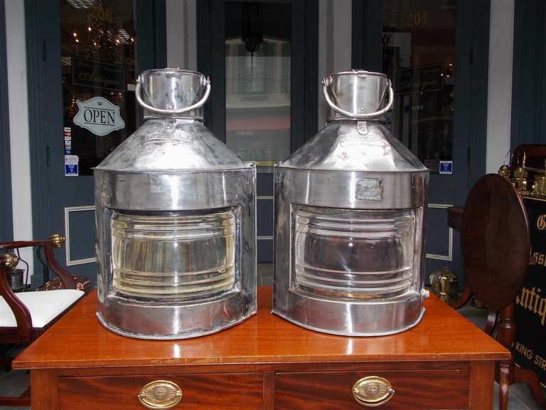 Pair of English port and starboard polished steel ship lanterns with Fresnel lenses, vented tops, and mounting handles. Meteorite Firm. Early 20th Century