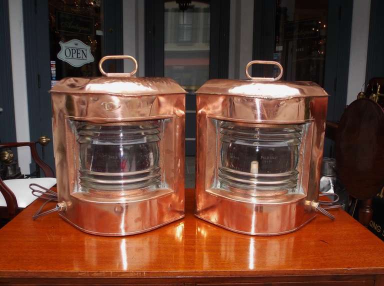 Pair of English copper  ship lanterns with fresnel lenses, hinged doors, and original carrying handles. Meteorite Firm. Early  20th Century.  Pair has been electrified.