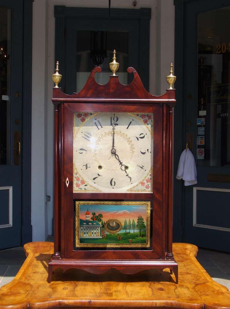 American mahogany pillar and scroll mantel clock with carved scrolled pediment, brass finials, original works, signed reverse painted glass, and terminating on tapered feet.  Clock has the original paper label. Eli terry and Sons,  Plymouth,