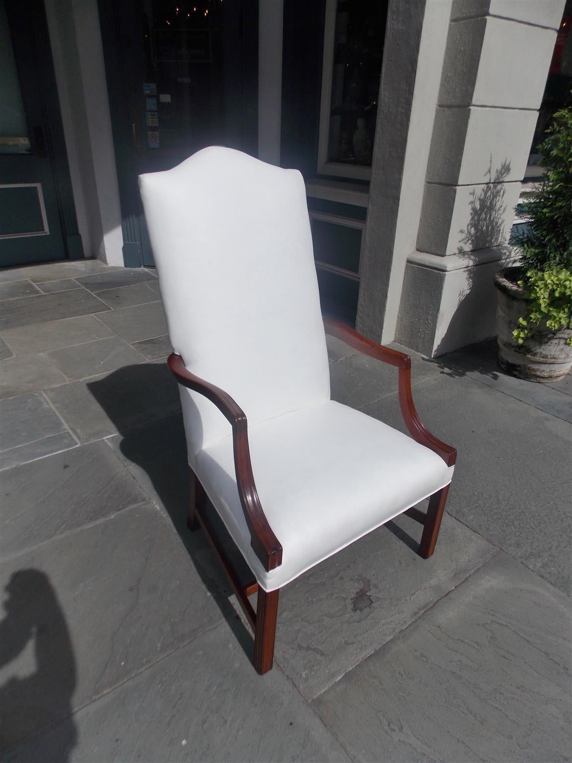 American mahogany Martha Washington armchair with serpentine slant high back, reeded scrolled and squared arms, terminating on reeded squared curvature legs with connecting stretchers. Chair is upholstered in white muslin with original horse hair