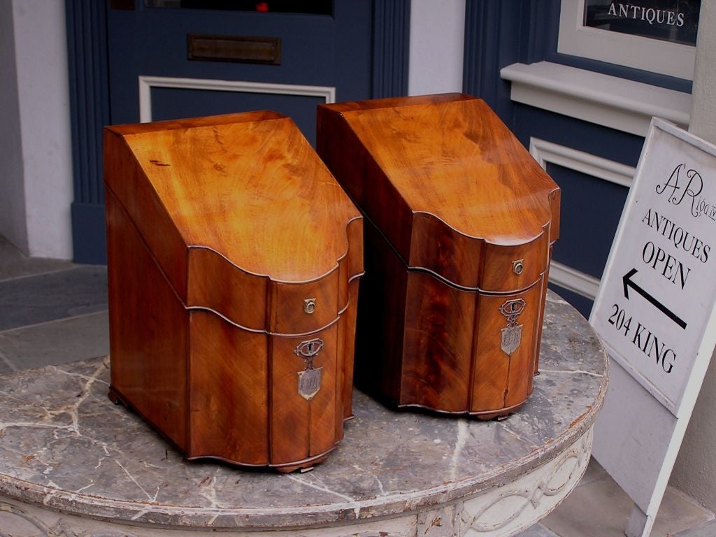 Pair of English mahogany slant top cutlery boxes with original inserts, satinwood sring inlay, original Paktong mounts, and ending on original feet.