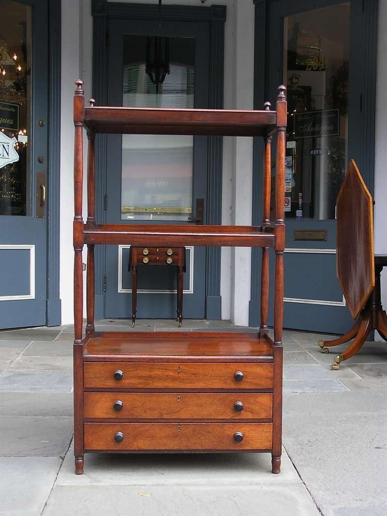 English Regency mahogany three tiered three drawer etegere with original ebonized knobs and original turned bulbous legs. Dealers please call or trade price.