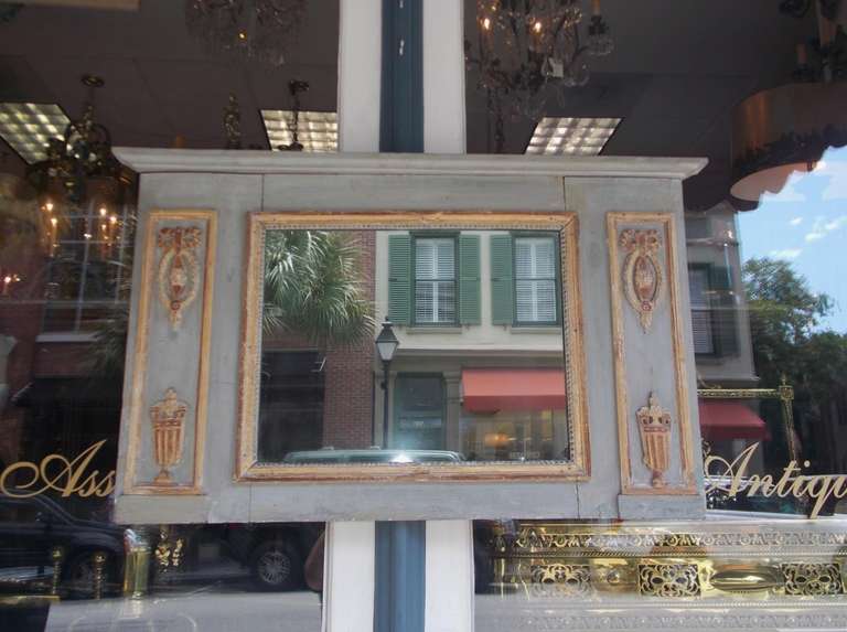 French painted and gilt wall mirror with carved ribbon, floral, and urn motif.  All original. Early 19th Century