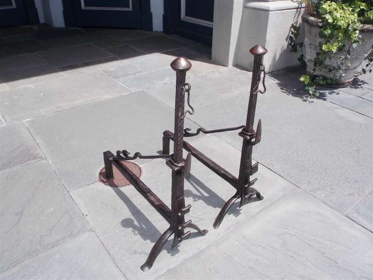 Pair of English wrought iron mushroom top andirons with hand chased feathering, spit hooks, tool holders, and terminating on original stylized penny feet.  Late 18th Century.