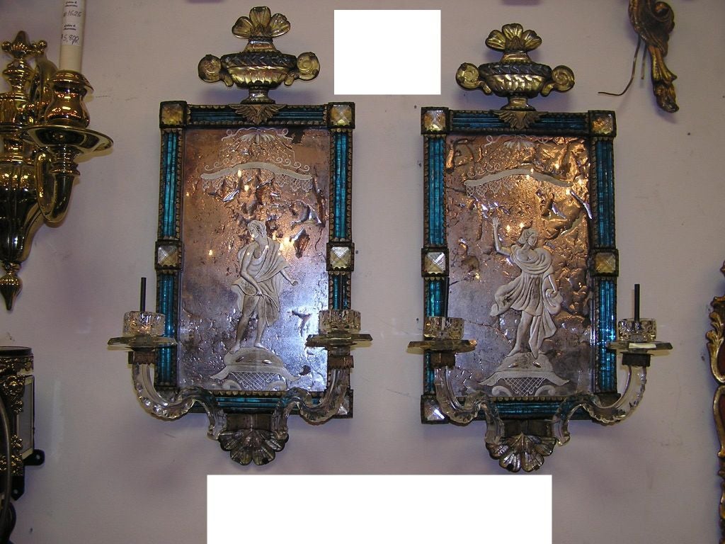 Pair of Venetian cobalt blue wall sconces with floral urns , medallions, & figure of lady and man acid etched in glass . Sconces are candle powered & can be electrified if desired . All original .  Early 18th Century