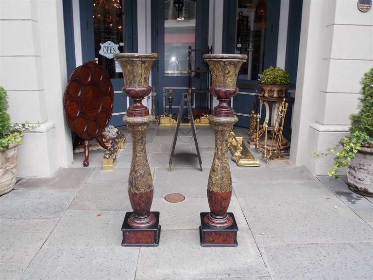 Pair of English slate faux painted campaign urns on bulbous fluted columns and terminating on rounded squared plinths. 19th Century