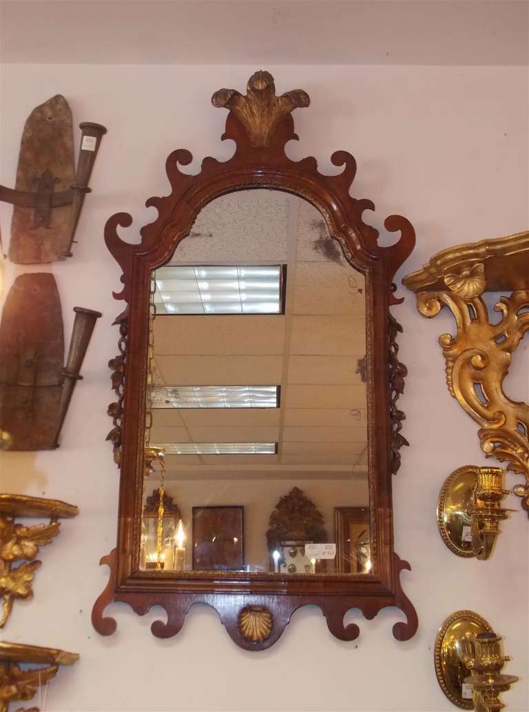English Chippendale mahogany gilt wall mirror with carved Prince of Wales plumes, shell,  and scrolling with floral motif.  Mirror retains the original glass and wood backing.  Late 18th Century