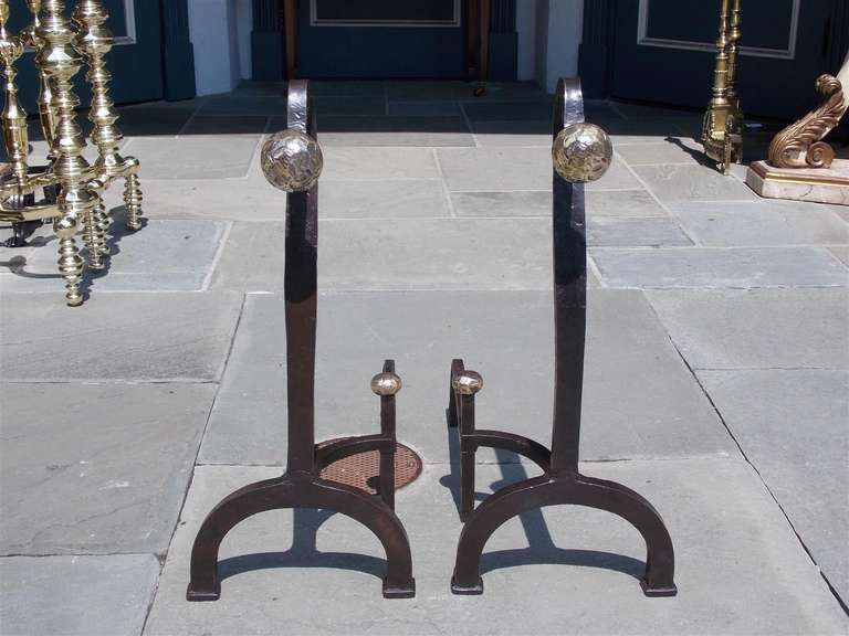 Pair of American goose neck wrought iron and bronze ball top andirons with matching log stops and scrolled feet.  Mid 19th Century