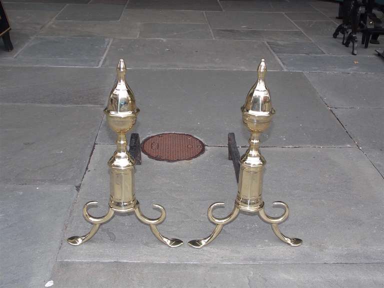 Pair of American faceted brass acorn finial andirons with faceted plinths, looped spurred legs, and terminating on stylized penny feet.  Philadelphia, Early 19th Century