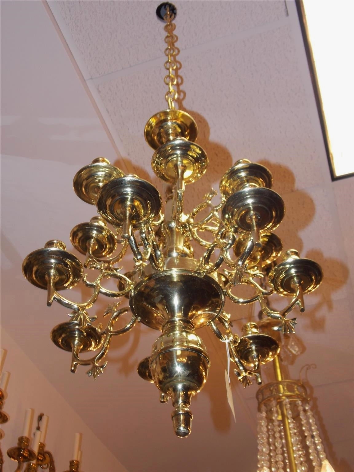 Dutch colonial two-tier 13-light chandelier with centered bulbous column, scrolled decorative arms, original bobaches and terminating with a brass ball finial. Mid-18th Century. Chandelier is candle powered and can be electrified if desired.