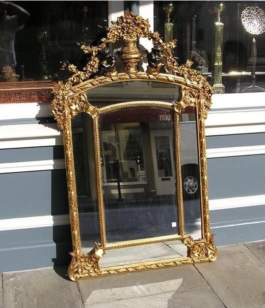 French carved wood & gilt five paneled wall mirror with center floral basket, ebonized cherubs, and acanthus carved floral corners. Early 19th Century