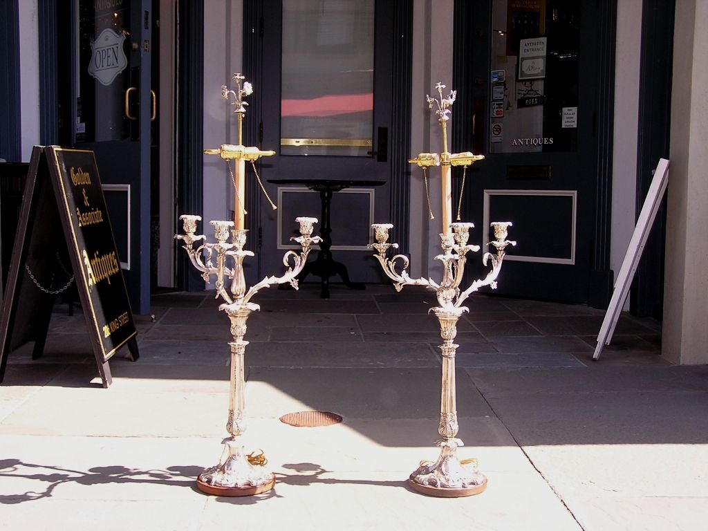 Pair of English three arm Sheffield Candelabras with trumpet floral finial ,  chased scrolled floral arms, and resting on chased floral wood bases.   Candelabras have been converted to table lamps. Can be converted back if desired. Late 18th Century