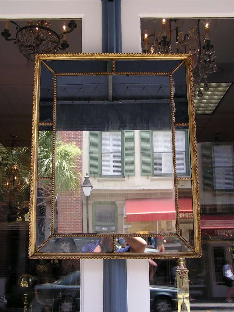 Venetian gilt carved wood paneled mirror with gadrooned molded edge and interior bead work. Mirror retains the original glass and wood backing. Second half 19th century.  