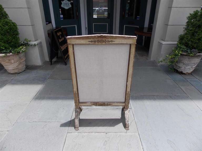 French gilt carved wood and painted free standing fire screen with floral medallion motif terminating on lions paw feet.  Dealers please call for trade price. 