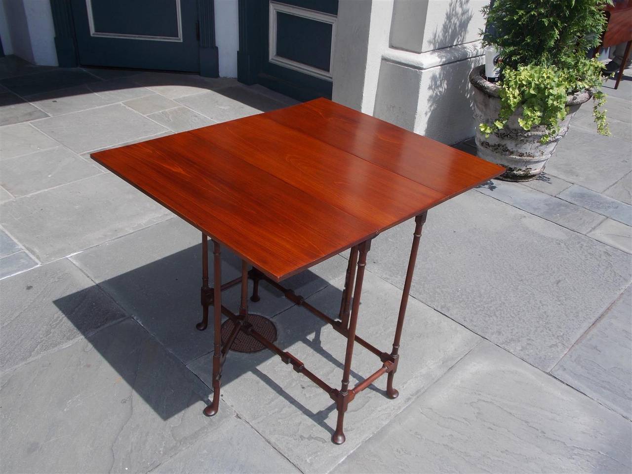 American mahogany drop-leaf spider leg table with turned ringed spindle legs, cross stretchers, and terminating on stylized Queen Anne pad feet, Late 19th Century. Table is 11.75