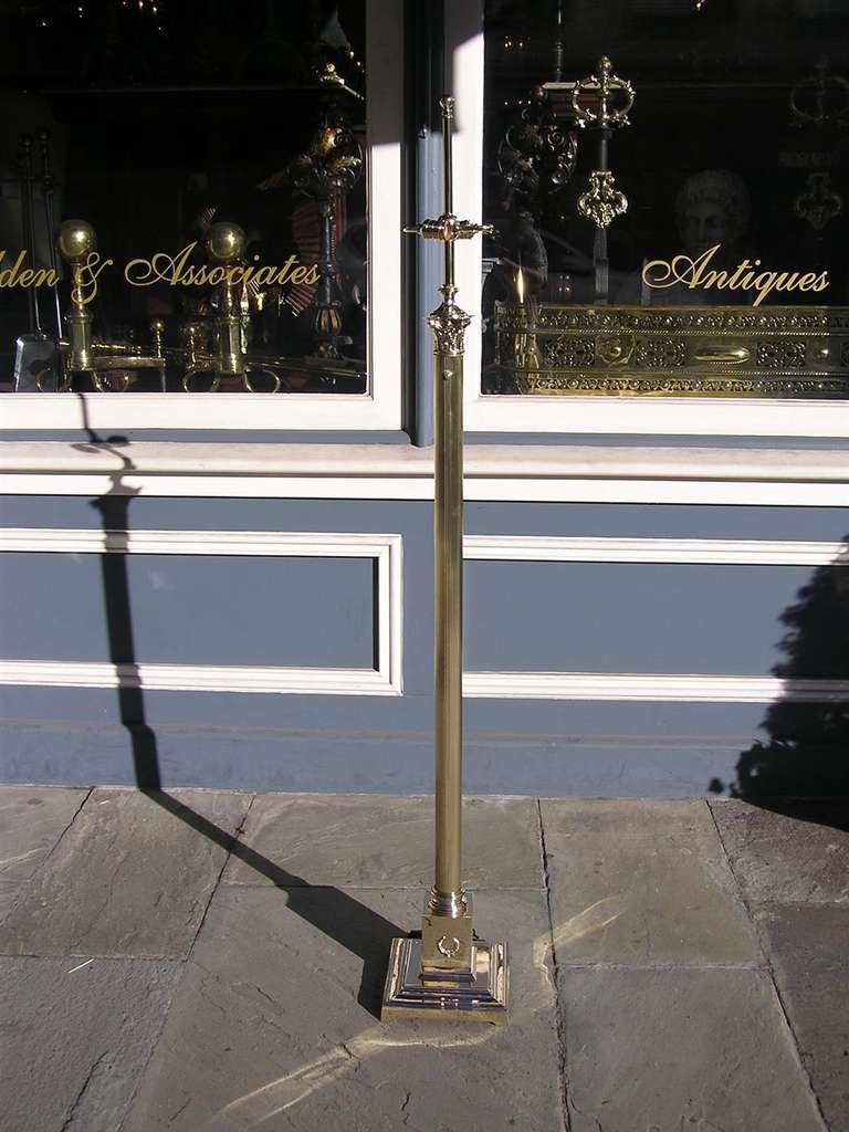 Zweiflammige Stehlampe aus amerikanischem Messing mit korinthischer, geriffelter Säule, die auf quadratischen Sockeln mit Lorbeerkranzmotiv endet. Ende des 19. Jahrhunderts.