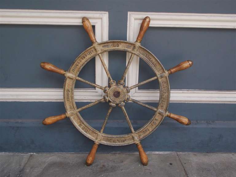 American cast iron ships wheel with eight iron spokes fitted with turned wooden handles and brass caps. Signed Wilcox Crittendon and Co. Middletown Connecticut.  Mid 19th Century