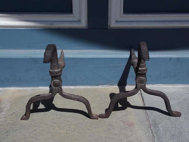 Pair of American Period wrought iron andirons with goose necks terminating on scrolled legs with stylized penny feet. Mid 18th Century