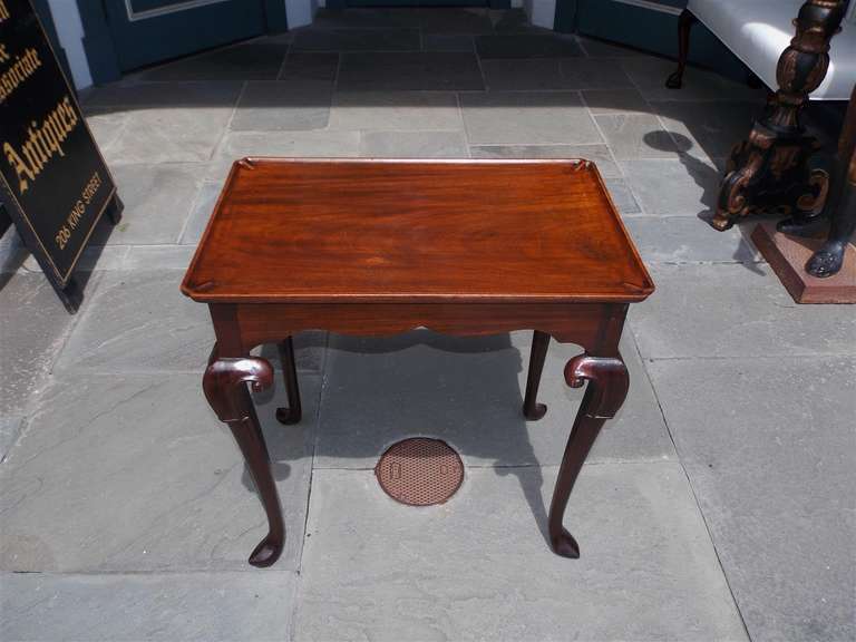 Irish Chippendale mahogany dish top tea table with carved foliage knee and terminating on stylized slipper feet. Mid-18th Century