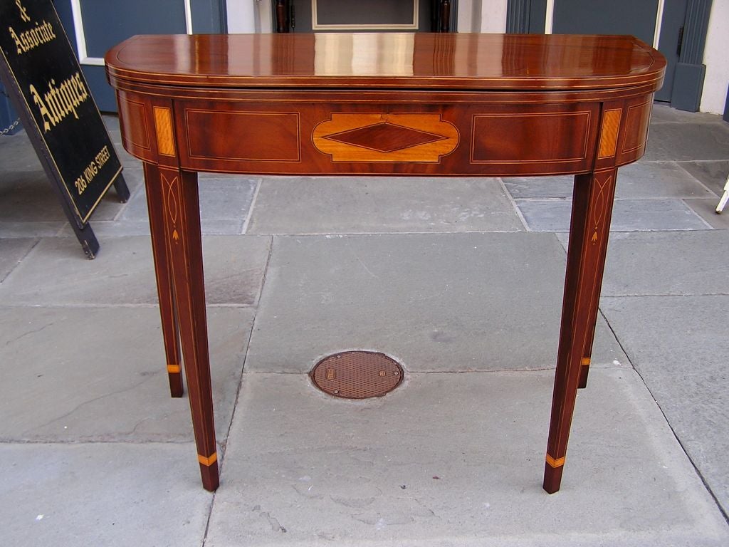 Charleston mahogany breadboard constructed card table with carved molded edge top, mahogany centered diamond surrounded by Tulip wood inlays & Satinwood inlaid panels, string inlays throughout, bell flower with upper and lower dots, single gate leg,