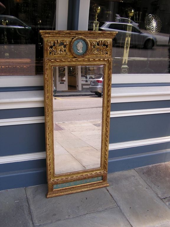 Italian gilt carved wood vanity mirror with floral fruit and scrolled ribbon motif. Retains the original mirror and has carved figure of lady and floral panel made of jasper ware.  Late 18th Century