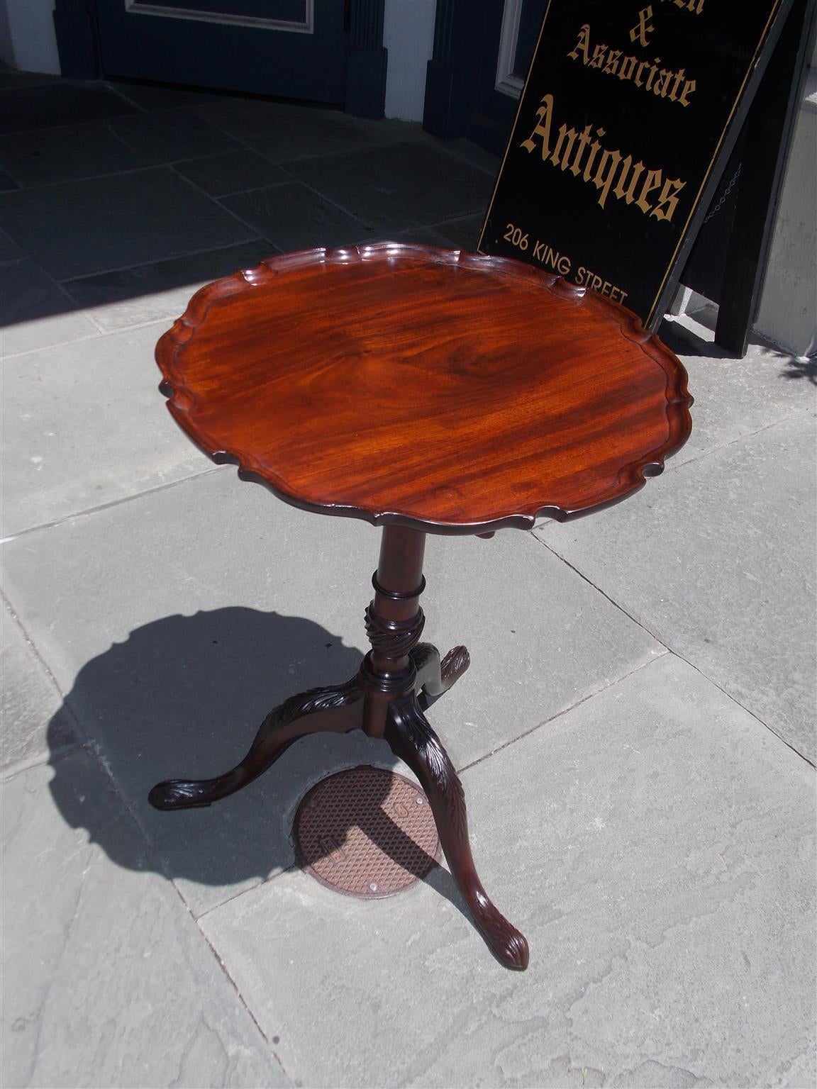 American Chippendale mahogany one board tilt-top tea table with carved pie crust edge, turned ringed spiral pedestal, and terminating on acanthus carved Drake feet, Late 18th Century.