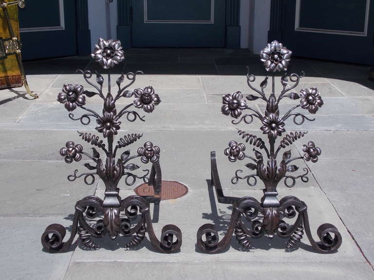 Pair of Italian wrought iron andirons with foliate petals, centered acanthus plinths, and terminating on hand chased scrolled legs. Early 19th Century