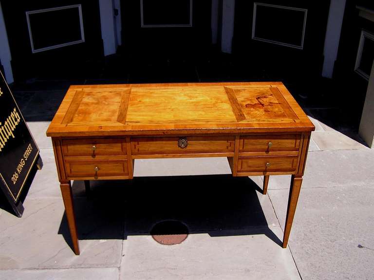 Italian Fruit wood five drawer writing desk with exotic inlays and cross bandings, original ormolu brasses, and terminating on original tapered legs.  Desk is finished on both sides. Mid 19th century.