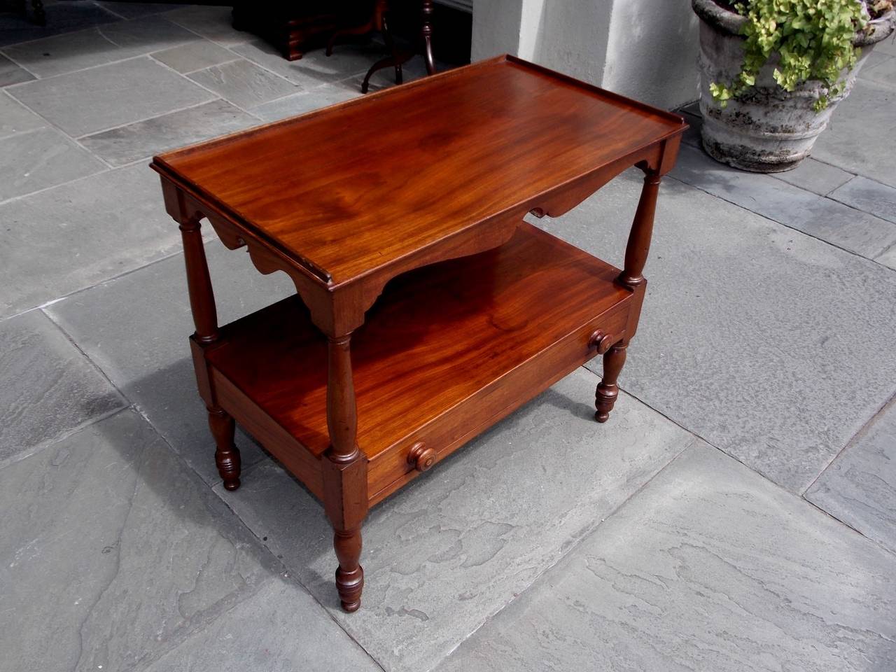 American walnut two-tier server with carved scalloped skirt, one-drawer with original wooden knobs, and terminating on turned bulbous legs, Early 19th Century.