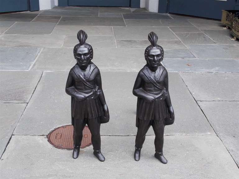 Pair of American cast iron figural Indian andirons with tomahawks and full dress attire. Mid 19th Century