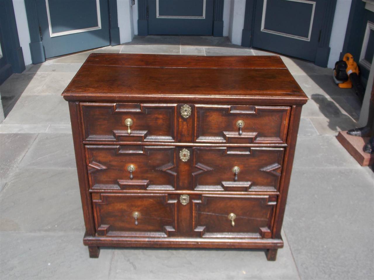 English oak Jacobean graduated three-drawer chest with original brasses, carved geometrical motif and terminating on a molded edge with original block feet. Secondary wood consist of deel (white pine), Mid-18th Century.