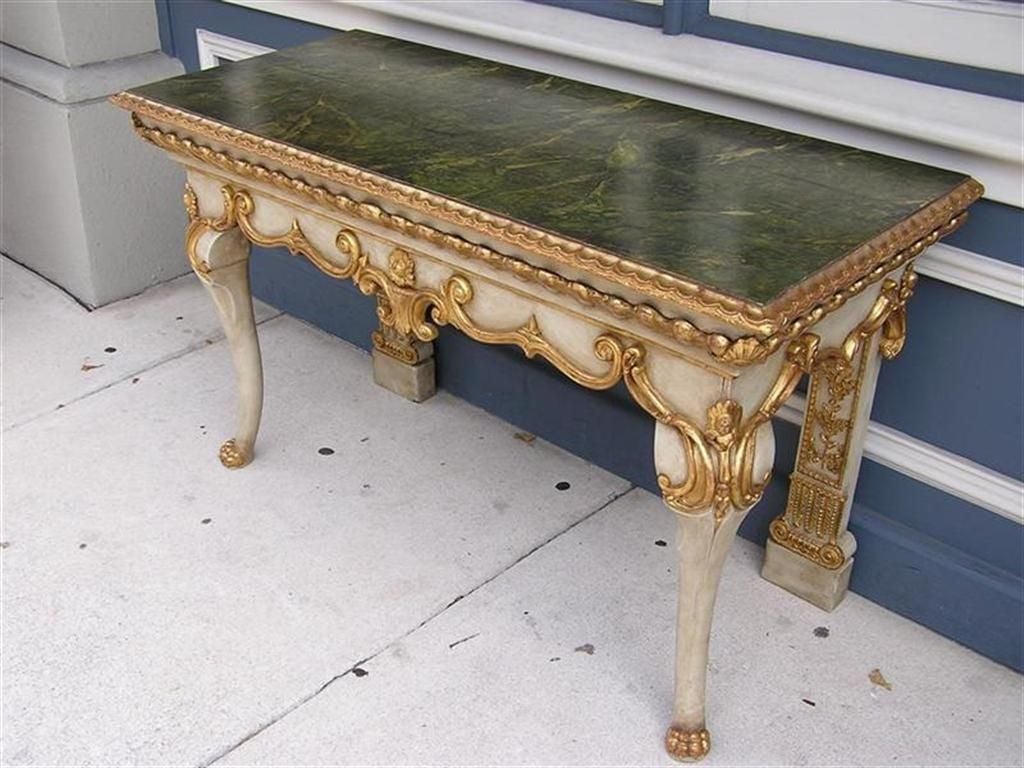 Italian painted and gilded console with carved floral scroll work, faux painted top, and gilded lions paw feet.