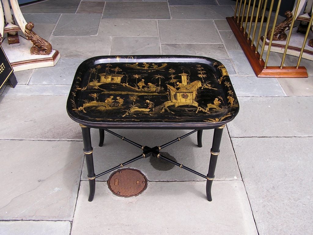 English chinoiserie gilt and stenciled paper mache tray on stand with turned bamboo style legs and stretchers. Stand was made for tray at later date.