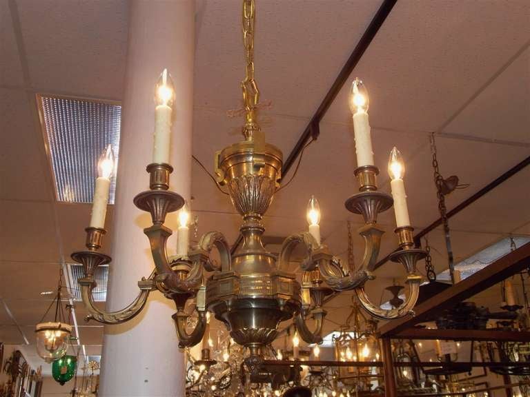 French gilt bronze six light chandelier with central urn finial, six scrolled acanthus foliage arms, and decorative fluted engraved chasing. Originally candle powered and has been electrified. Mid 19th Century