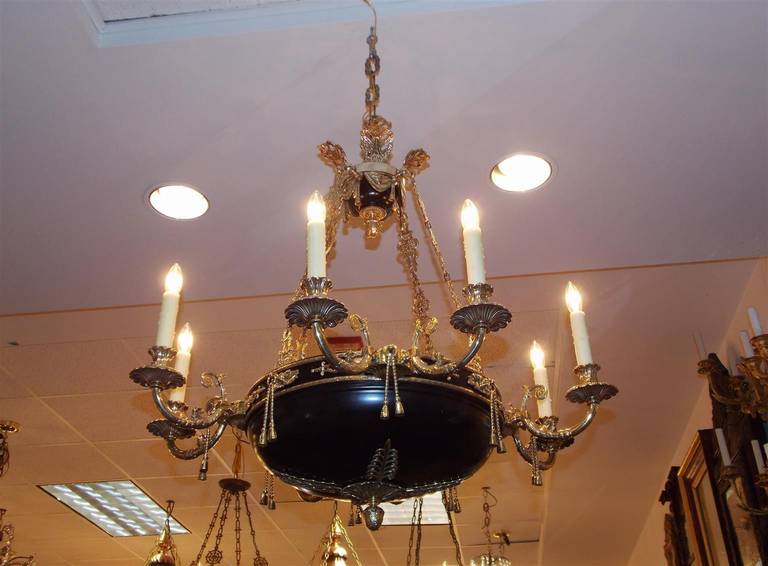 French painted and bronze 8 light chandelier with scrolled medallion arms, decorative tassels, swags, and floral motif. Chandelier was originally candle powered and has been electrified. Mid-19th Century
