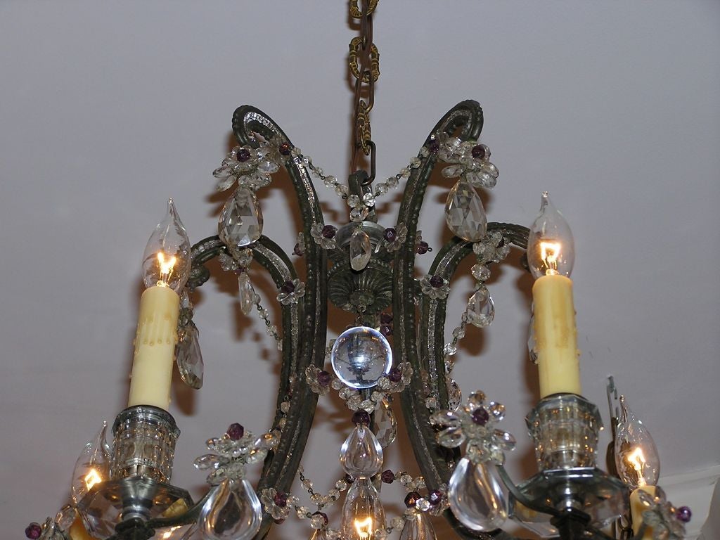 French bronze and crystal six light chandelier with scrolled arms, intertwined bead work, and amethyst floral prisms.  (Maison Bagues )