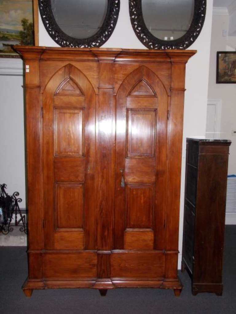 American Federal white pine two door armoire with arched doors, carved moldings, fitted interior till, shelving,  and terminating on tapered block feet.  Dealers please call for trade price.