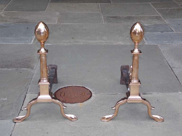 Pair of American bell brass lemon top andirons with turned rounded squared plinths, matching finial lemon log stops, and terminating on spurred legs with slipper feet.  Boston,  The S.M. Howes Company