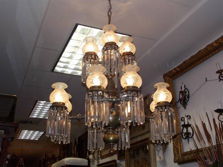 American bronze and crystal twelve light gasolier with original etched globes.  Chandelier has been converted to electricity. Early 19th Century.