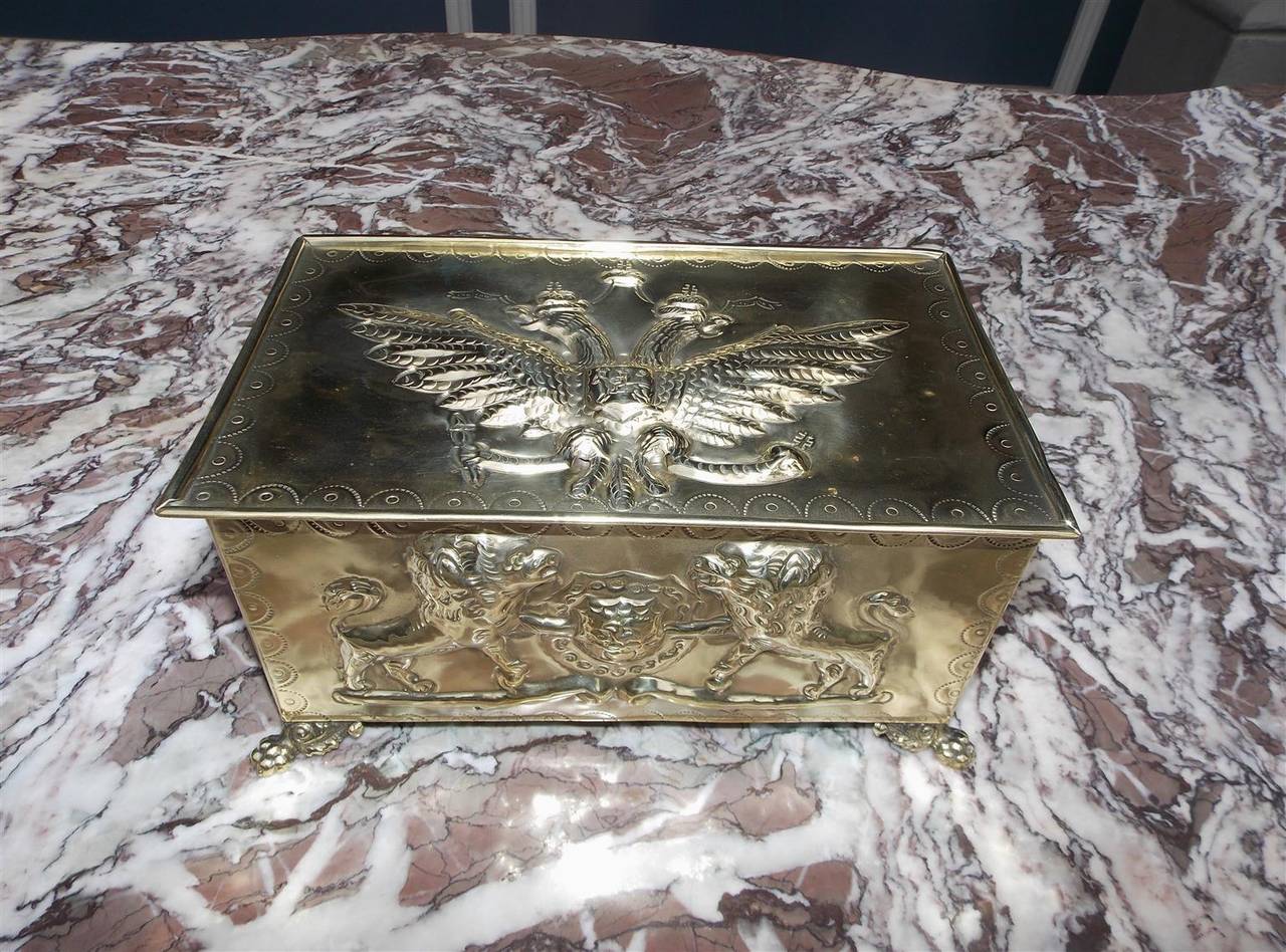 Russian embossed brass box with double eagle, flanking lions with crest, decorative hand chase work, lions head side handles, original tin liner and resting on acanthus lions paw feet, Early 19th century.