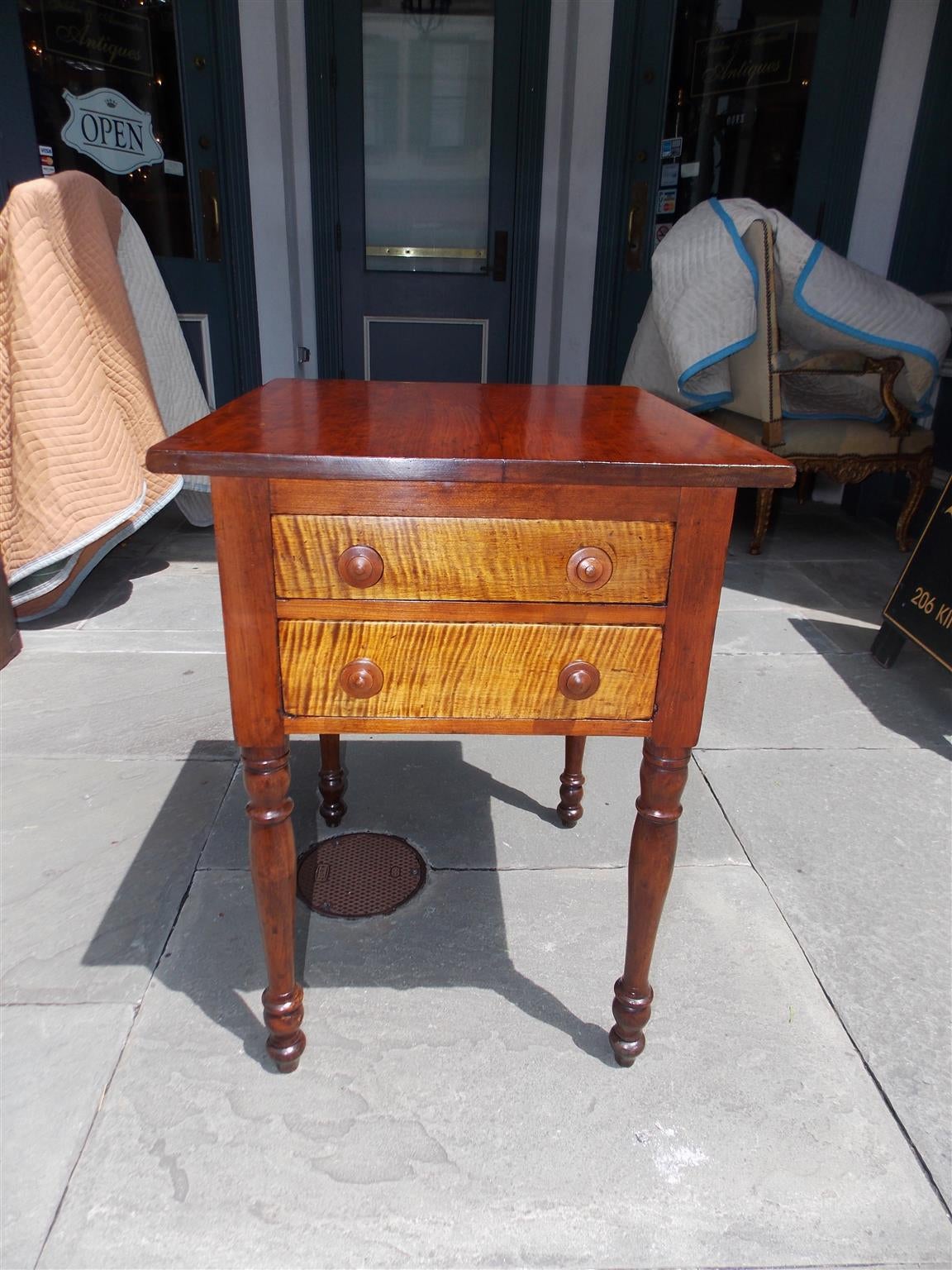 American Sheraton Cherry and tiger maple two-drawer stand with original wood knobs and turned ringed bulbous legs. Table is finished on all sides, Early 19th Century.